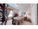Inviting bedroom with a vintage-style bed, cozy lamps, and a window with decorative curtains at 2819 47Th E St, Palmetto, FL 34221