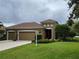 Charming home featuring a three-car garage, manicured lawn and decorative architectural details at 2819 47Th E St, Palmetto, FL 34221