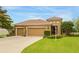 Charming one-story home with a three-car garage, landscaped yard, and freshly cut lawn at 2819 47Th E St, Palmetto, FL 34221