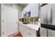 Bright kitchenette featuring white cabinets, stainless steel appliances, granite countertops, and a convenient sink at 2819 47Th E St, Palmetto, FL 34221