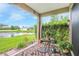 Covered patio with outdoor seating, offering a serene view of the lush backyard and water feature at 2819 47Th E St, Palmetto, FL 34221