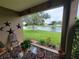 Relaxing covered patio with outdoor seating area, providing a picturesque view of the serene pond and well-manicured lawn at 2819 47Th E St, Palmetto, FL 34221