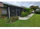 Outdoor living with a screened patio surrounded by lush landscaping, including flowering shrubs at 2819 47Th E St, Palmetto, FL 34221