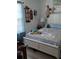 Cozy bedroom featuring a queen-sized bed, wooden accents, and natural light from the window at 5231 Brassy Loop, North Port, FL 34287