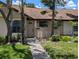 Charming townhome featuring a walkway leading to the front door and complemented by manicured landscaping at 5231 Brassy Loop, North Port, FL 34287