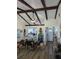 Bright living room featuring exposed beams and view to the kitchen at 5231 Brassy Loop, North Port, FL 34287
