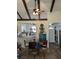 Spacious living room with vaulted ceilings, wooden beams, and an open design to the kitchen and front entrance at 5231 Brassy Loop, North Port, FL 34287