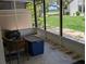 Cozy enclosed patio featuring a comfortable wicker chair at 5231 Brassy Loop, North Port, FL 34287