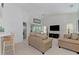 Spacious living room with neutral decor, comfortable seating, and views of the screened-in lanai at 802 Montrose Dr # 204, Venice, FL 34293