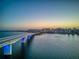 Scenic aerial view of a bridge over the water, connecting to a vibrant city skyline at sunset at 8697 Milestone Dr, Sarasota, FL 34238