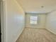 Empty bedroom with neutral walls, plush carpet and a window for natural light at 8697 Milestone Dr, Sarasota, FL 34238