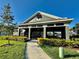 Inviting community clubhouse featuring a covered entrance, manicured landscaping, and a welcoming walkway at 8697 Milestone Dr, Sarasota, FL 34238