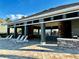 Relaxing clubhouse patio featuring comfortable lounge chairs, shaded seating areas, and a built-in grill at 8697 Milestone Dr, Sarasota, FL 34238