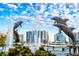 Whimsical waterfront dolphin fountain in a bay with skyline and boat views at 8697 Milestone Dr, Sarasota, FL 34238