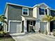 Attractive two-story townhome with attached garage and manicured landscaping at 8697 Milestone Dr, Sarasota, FL 34238