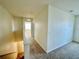 Upstairs hallway with neutral walls and plush carpet at 8697 Milestone Dr, Sarasota, FL 34238