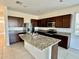 Spacious kitchen with granite countertops, stainless steel appliances, and a center island at 8697 Milestone Dr, Sarasota, FL 34238