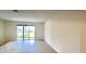 Bright, open concept living space with sliding glass doors for natural light and tile flooring at 8697 Milestone Dr, Sarasota, FL 34238