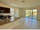 Open floor plan featuring sliding glass doors for natural light and tile flooring at 8697 Milestone Dr, Sarasota, FL 34238