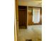 Empty bedroom with wood paneling, air conditioner, and closet at 126 W North St, Tampa, FL 33604