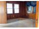 Bedroom featuring wood paneling, two windows, and an air conditioning unit at 126 W North St, Tampa, FL 33604