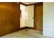 Empty bedroom features wood paneling, doors to closet and bathroom at 126 W North St, Tampa, FL 33604