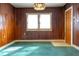 Cozy dining room showcasing wood paneling and a vibrant turquoise rug at 126 W North St, Tampa, FL 33604