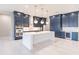 Modern kitchen with white quartz island, navy blue cabinetry, and gold accents at 2073 Treasure Ln, Punta Gorda, FL 33982