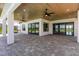 Large covered patio with wood ceiling, multiple ceiling fans, and paver stone flooring at 2073 Treasure Ln, Punta Gorda, FL 33982