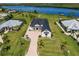 Modern home on waterfront lot with paved driveway and palm trees at 2073 Treasure Ln, Punta Gorda, FL 33982
