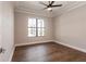 Bedroom with hardwood floors and large window overlooking a patio at 2073 Treasure Ln, Punta Gorda, FL 33982