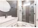 Modern bathroom with a glass shower, herringbone tile, and white vanity at 2073 Treasure Ln, Punta Gorda, FL 33982