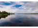 Calm water view with reflection of clouds and trees at 2073 Treasure Ln, Punta Gorda, FL 33982