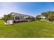 Spacious backyard with a screened lanai and lush landscaping at 2073 Treasure Ln, Punta Gorda, FL 33982