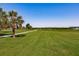 Waterfront property with a manicured lawn and walkway at 2073 Treasure Ln, Punta Gorda, FL 33982