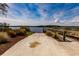 Concrete boat ramp leading to a wooden dock and calm waterway at 2073 Treasure Ln, Punta Gorda, FL 33982