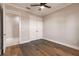 Bright bedroom featuring hardwood floors and double doors leading to en-suite bathroom at 2073 Treasure Ln, Punta Gorda, FL 33982