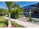 Landscaped backyard with a walkway leading to the pool area at 2073 Treasure Ln, Punta Gorda, FL 33982