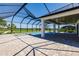 Screened pool and spa with spacious patio, offering picturesque water views at 2073 Treasure Ln, Punta Gorda, FL 33982