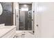Modern bathroom with a glass shower, herringbone tile, and white vanity at 2073 Treasure Ln, Punta Gorda, FL 33982