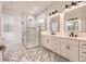 Elegant bathroom with double vanity, walk-in shower, and patterned tile floor at 2073 Treasure Ln, Punta Gorda, FL 33982