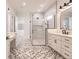 Elegant bathroom with double vanity, walk-in shower, and patterned tile floor at 2073 Treasure Ln, Punta Gorda, FL 33982