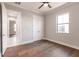 Bedroom with hardwood floors, ceiling fan and access to another room at 2073 Treasure Ln, Punta Gorda, FL 33982