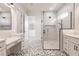 Elegant bathroom with double vanity, walk-in shower, and patterned tile floor at 2073 Treasure Ln, Punta Gorda, FL 33982