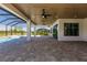Spacious covered patio with pool view, wood ceiling, and multiple fans at 2073 Treasure Ln, Punta Gorda, FL 33982