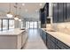 Modern kitchen with white and navy cabinets, quartz countertops, and island at 2073 Treasure Ln, Punta Gorda, FL 33982