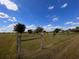 Open pasture with a pond, trees and a rustic fence at 48665 Bermont Rd, Punta Gorda, FL 33982