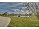 Serene pond with a bench, overlooking the property at 48665 Bermont Rd, Punta Gorda, FL 33982