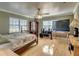 Spacious bedroom with wood floors, large TV, and ample closet space at 48665 Bermont Rd, Punta Gorda, FL 33982
