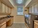Laundry room with built-in workspace and storage at 48665 Bermont Rd, Punta Gorda, FL 33982